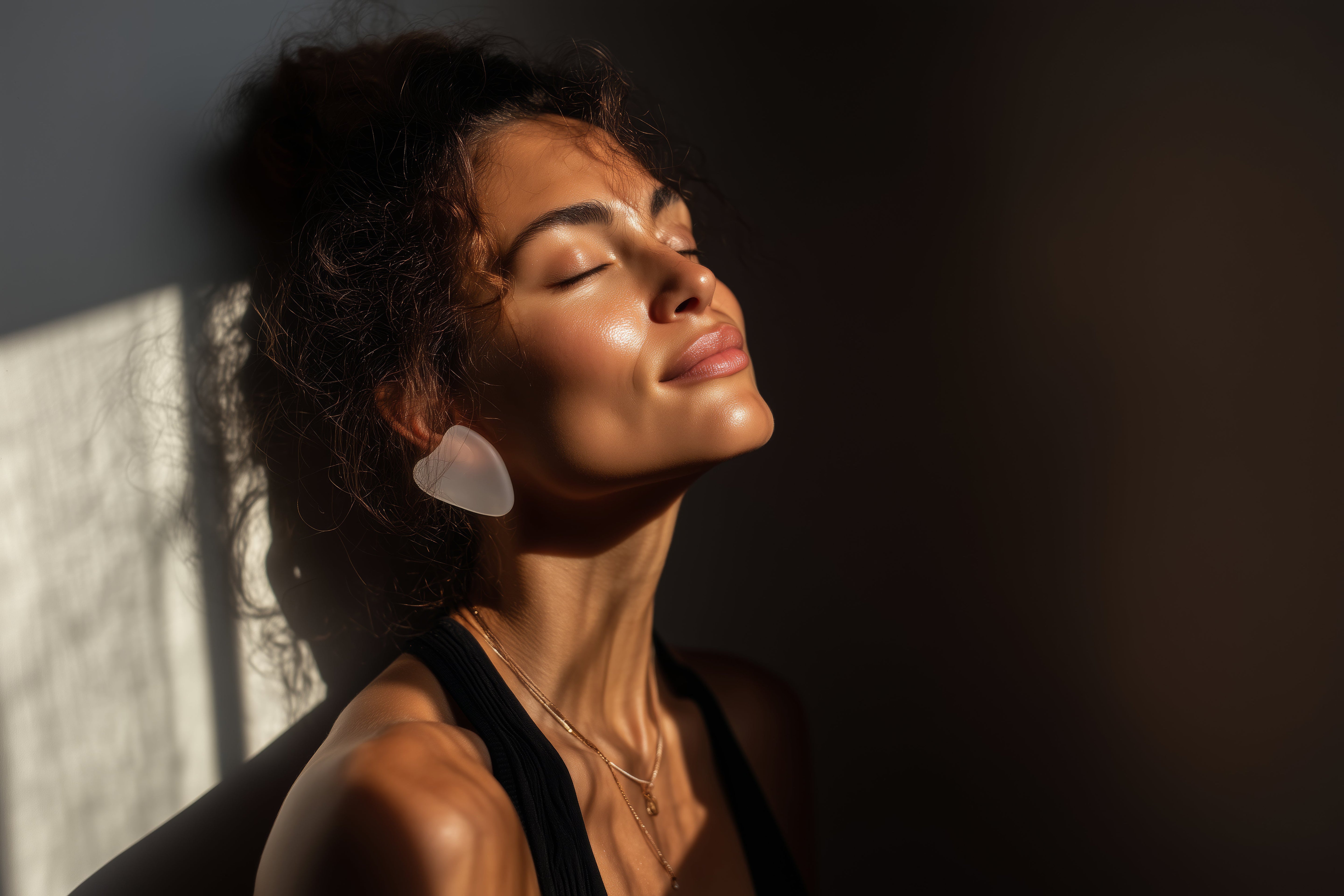 Woman with glowing skin enjoying the morning sun