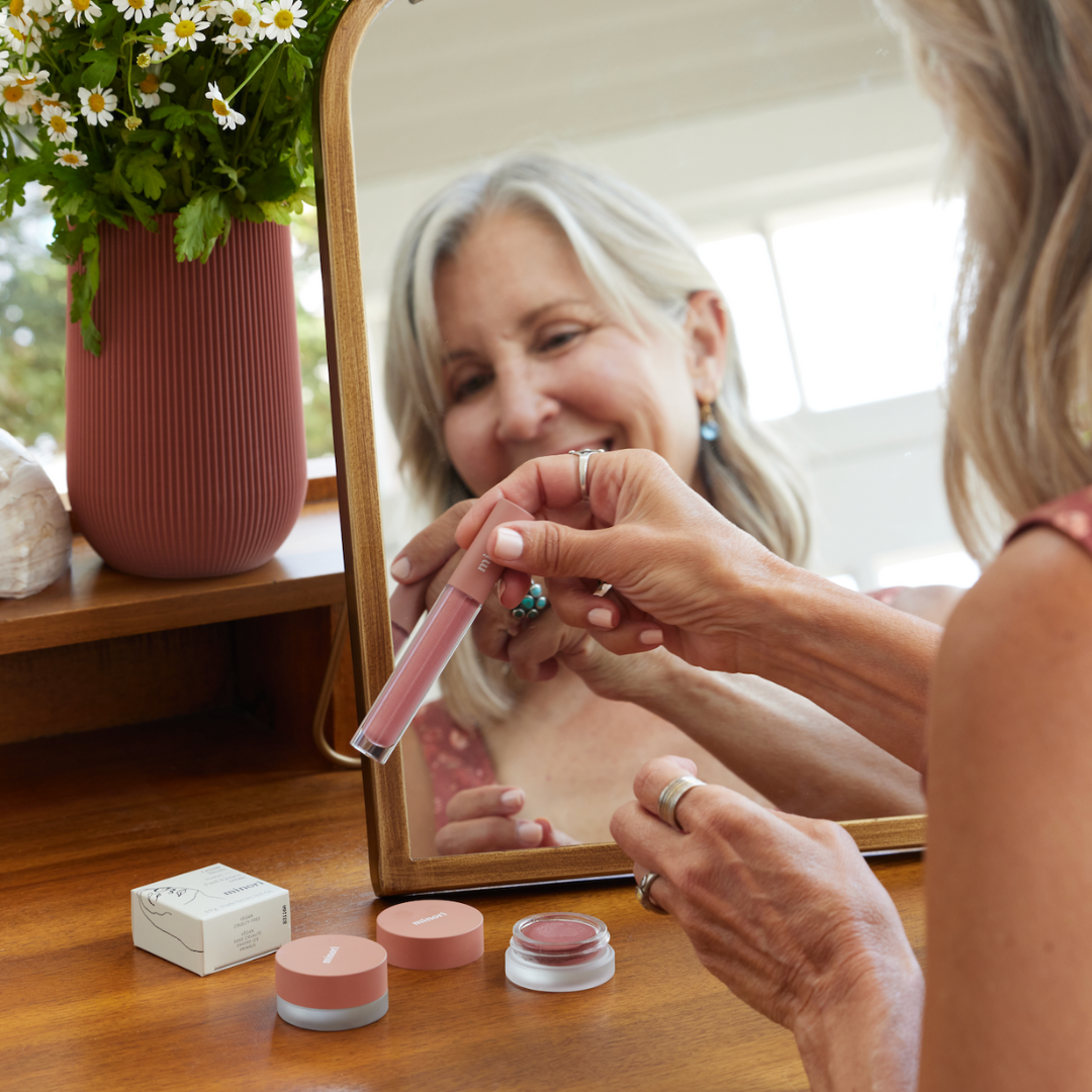 Woman using Minori in the mirror